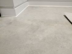 an empty room with white walls and carpet