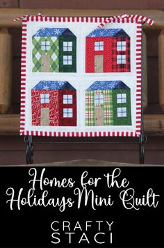 a red and green quilted house with the words homes for the holidays mini quilt on it