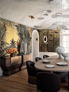 the dining room is decorated with tropical wallpaper and modern chairs, along with an oval wooden table