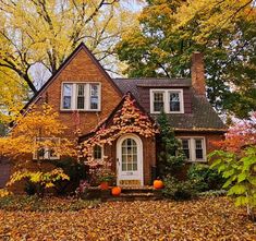 a small brick cottage is surrounded by leaves and yellow trees in autumn. American Foursquare, Fairytale House, Tudor Revival, England Homes, Tudor Style Homes, Craftsman Style Homes, October 1st, Cute House, Sims House