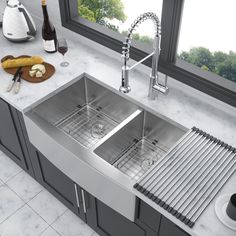 a stainless steel double bowl kitchen sink