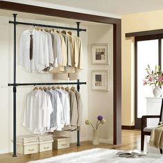 an open closet with clothes hanging on the rails and shoes in front of it, next to a chair