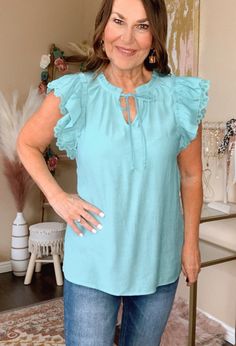 You will feel amazing in the Pretty Girl Lace Blouse. It has a keyhole Tie neck in front, a double layer lace cap sleeve, and is a textured solid color with a straight bottom hem. Dress it up or go casual and it look fabulous either way. Also comes in Coral. 100% Polyester 0-4 Small 5-9 Medium 10-12 Large Casual Blouse With Lace Top And Ruffle Sleeves, Casual Lace Top Blouse With Ruffle Sleeves, Solid Color Summer Lace Top, Solid Color Lace Top For Summer, Summer Lace Top In Solid Color, Ruffled Tops For Beach, Beach Blouse With Ruffles, Lace Sleeve Blouse, Lace Caps