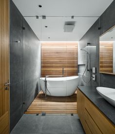 a large white bath tub sitting inside of a bathroom next to a walk in shower