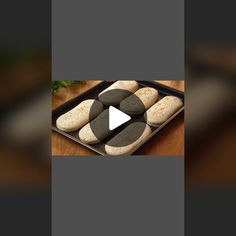 a pan filled with black and white cookies on top of a wooden table