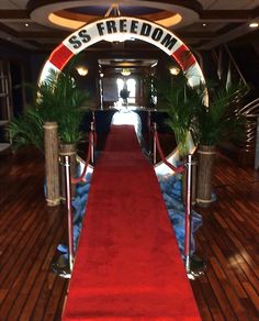 a red carpeted hallway leading to the entrance