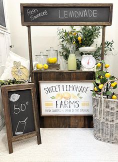 a lemonade stand with fresh squeezed lemons and an old fashioned chalkboard sign