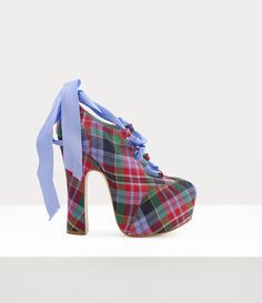 First shown in our Spring-Summer 1993 'Anglomania' collection in Paris, the Elevated Ghille platforms feature elements reminiscent of ghillie brogues, traditional Scottish shoes worn with Highland dress, but exaggerated and elevated to create a bold statement. This season, the piece is offered in the 'Circus Tartan' motif, complete with ribbon laces. Ghillie Shoes, Ghillie Brogues, Pink Nike Shoes, Tartan Design, Pink Nikes, Ballerina Shoes, Naomi Campbell, Runway Show, Dream Shoes