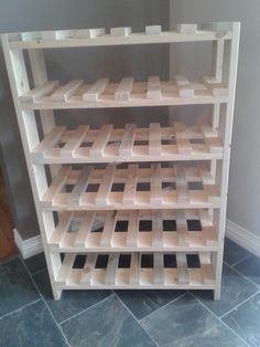 a wooden shelf sitting on top of a tiled floor