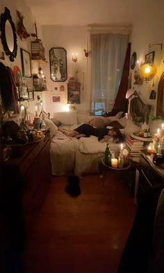 a living room filled with furniture and lots of candles on the floor next to a window