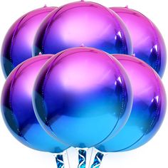 purple and blue balloons are stacked on top of each other in front of a white background