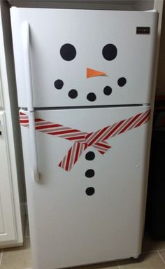 a refrigerator decorated like a snowman with red and white stripes on its front door