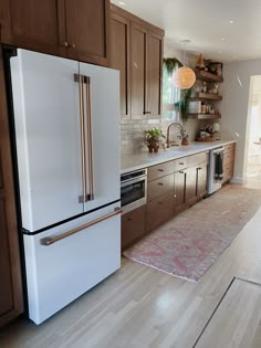 a white refrigerator freezer sitting inside of a kitchen