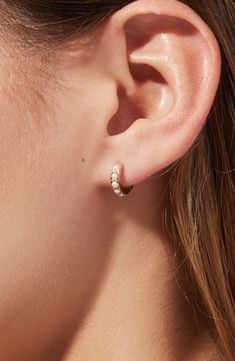 Featuring lustrous Swarovski pearls in a pavé setting, these elegant pearl huggie hoops are this season’s must-have. Carefully crafted in 100% recycled Sterling Silver and dipped in 14k gold, these pearl huggie hoops will add a dainty vibe to any outfit. Recycled Sterling Silver huggies with a thick 14k gold coating Feature perfect Swarovski pearls in a pavé setting Comfortable to wear & hypoallergenic Width:11.6mm - 0.5" Depth: 1.9mm - 0.1" Weight: 1g Hoop Diameter: 11.6mm - 0.5" Post: Stainles Double Piercing Wedding Earrings, Wedding Earrings Rose Gold, Every Day Earrings, Pearl Earrings Wedding The Bride, Pearl Stud Earrings Simple, Simple Drop Earrings, Gold Dainty Earrings, Dainty Pearl Jewelry, Huggie Earrings Aesthetic