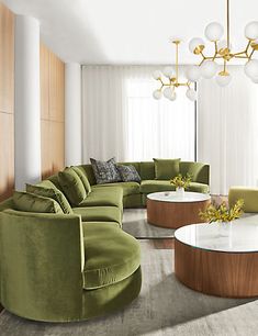 a living room filled with lots of green furniture