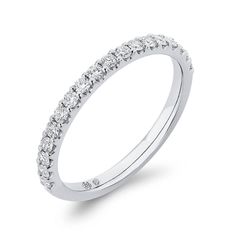 a white gold wedding band with rows of diamonds on the side and an open diamond set in