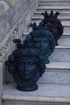 three decorative vases sitting on the steps