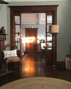 a living room filled with furniture and a fire place in front of a wooden door