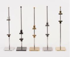 four different types of metal and wood stand on top of each other in front of a white background