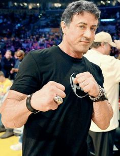 a man in black shirt holding two rings