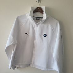 a white bmw jacket hanging on a wall