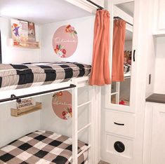 a bunk bed with black and white checkered blanket on it's bottom shelf