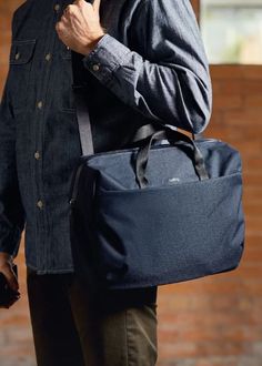 This navy Via Work Bag features a padded 16” laptop sleeve with an ultra-wide zip opening for easy access. The main compartment is surprisingly spacious and includes a raised internal mesh zip pocket. An external quick-access pocket with key clip allows for convenient organization. The bag also has a detachable padded shoulder strap, soft rolled-edge webbing handles, and a water-resistant main zipper. A luggage pass-through slides over a suitcase handle for added convenience. Plus, this bag is made from recycled ripstop material and does not contain any leather components. Fits 16" Laptop Detachable shoulder strap 15.5" x 12.5" x 5.5" Capacity: 14L Laptop Bag Men, Suitcase Handle, Key Clip, Bottle Bag, Mens Skin Care, Work Bag, Water Resistant Fabric, Reusable Bags, Leather Design