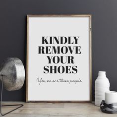 a black and white poster with the words kindly remove your shoes