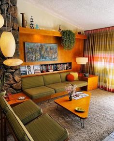 a living room filled with furniture next to a stone wall and wooden bookshelf