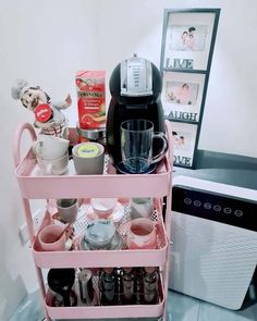 a pink cart filled with coffee cups and other items