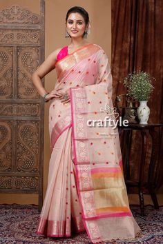 Indulge in the sophisticated allure of our Tissue Organza Silk Saree in Light Peach. Made from premium quality Tissue Organza fabric, this saree exudes a sense of effortless grace. The Zari border and rich pallu add a touch of opulence, making it the perfect choice for any special occasion. Accompanied by a complementing running blouse piece, this saree offers versatile styling options. The lightweight fabric allows for comfortable draping and all-day wear. Elevate your traditional wardrobe with this exquisite saree.Saree Length : 5.5 Mtr Blouse Piece Length : 0.8 Mtr Design : Flower Motif Zari Work Fabric : Tissue Organza Wash Care : Dry Clean Get this exclusive soft silk saree online at Craftyle - The best online store for pure silk saree, tussar silk saree and cotton saree. Peach Chanderi Saree With Cutdana, Peach Chanderi Saree With Dupatta, Peach Chanderi Saree For Diwali, Peach Semi-stitched Chanderi Saree, Festive Peach Chanderi Blouse Piece, Elegant Peach Saree With Cutdana Detail, Elegant Peach Saree With Cutdana, Peach Saree With Zari Weaving For Diwali, Peach Saree With Traditional Drape