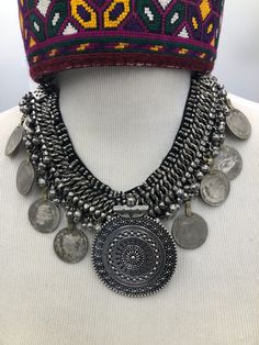 *This oxidized silver coin necklace is a divine piece of the tribe of Kuchi. Drooping silver bells with coins augment the glamour of this elegant necklace. This necklace is bold and attractive. This vintage necklace is handcrafted by outstanding craftsmen. Made up of the best quality material this necklace is one of the stunning necklaces in our collection. *The necklace consists of nine semi silver coins from which the one in the center is the eye-catchy one. The details and design of this neck Bohemian Coin Necklace In Metal, Bohemian Coin Metal Necklace, Bohemian Coin-shaped Metal Necklace, Bohemian Antique Silver Necklace For Ceremonial Occasions, Handmade Metal Coin Necklace For Festival, Bohemian Round Necklace For Ceremonial Use, Bohemian Round Necklace For Ceremonial Occasions, Bohemian Round Ceremonial Necklace, Festival Medallion Necklace With Coin Pendant