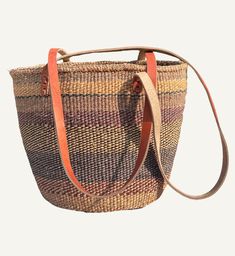 The Sophia will be on our shoulder all summer long. We can't wait to carry this vintage inspired sisal bag to the beach and while shopping in town. The Sophia is a perfect everyday bag that is roomy enough for essentials and more. 11" high by 12" wide by 6" deep. 17.5" handle drop. Made by a wonderful group of women artisans in Kenya. No inside pocket. 100% Sisal Body. Leather Strap. Brown Straw Bag With Adjustable Strap For Market, Beige Basket Shoulder Bag With Rolled Handles, Brown Basket Beach Bag For Travel, Brown Jute Bucket Bag With Handles, Brown Beach Bag With Rolled Handles For Vacation, Brown Shoulder Bag With Natural Fiber Handles, Brown Basket Beach Bag With Handles, Casual Brown Bucket Bag With Rolled Handles, Brown Straw Bag With Rolled Handles