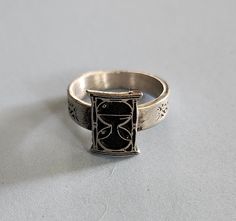 This ring was designed with the hour glass symbol. The beautiful pewter ring is a silver color and the background is blackened to bring out the fine detail of the design. Our rings are 100% Lead and nickel free pewter and made in the USA The top design part of the ring measures approx. 12.5mm x 9.5mm  The ring band tapers from about 5mm to about 4mm at the bottom and is about 1.5mm thick Picture shows size compared to a US Dime Rings are available in sizes 4 to 7 (half sizes also) Pewter Ring, Hour Glass, Top Design, Ring Band, Rings Statement, Band Rings, Silver Color, Statement Rings, Jewelry Rings