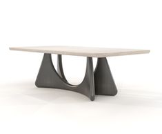 a white table sitting on top of a white floor next to a black object with two curved legs