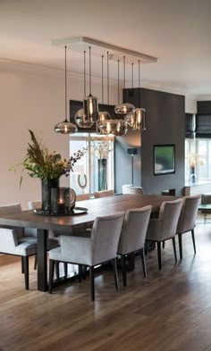 the dining room table is surrounded by gray chairs