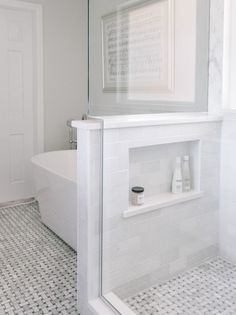 a bathroom with a white bathtub and tiled floor