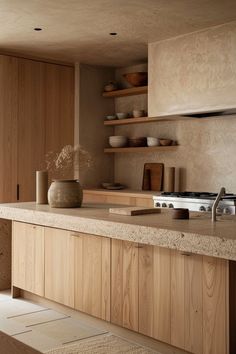 a kitchen with wooden cabinets and counter tops in the center, along with an oven