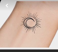 a small sun and moon tattoo on the back of a woman's arm,