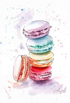 a stack of macaroons sitting on top of each other in front of a watercolor background