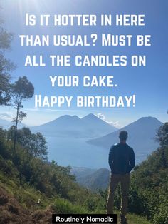 a man standing on top of a hill with the words happy birthday in front of him