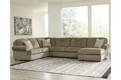 a living room with a sectional couch and rug