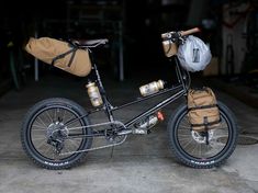 a black bike with brown bags on the back