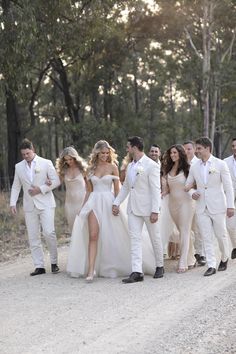 the bride and grooms are walking down the road