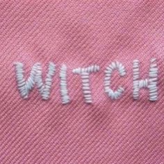 the word witch is embroidered onto a pink shirt with white thread on it's chest