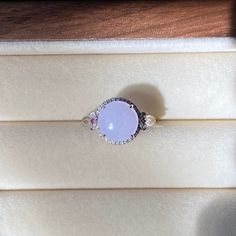 Ice Lavender Jade Ring, pinkish purple Jade Ring, 18K White Gold Jade Ring, Natural Grade A Burmese Jadeite Jade (18K金冰紫蛋面戒指)  ‼️Please contact us for the ring size‼️‼️ Color: Ice Lavender/Purple Jade Dimensions: 9.3×4mm Ring Size: 6.5（US) Material: 18k Rose Gold With Diamond  Genuine type A jade, 100% natural, No chemical bleaches and/or acids and impregnating. No artificially stained or dyed. Jade is a natural product that always has imperfections. These are considered to be part of the beauty and uniqueness of the jade stone. On different backgrounds, jade will show a bit different color, please take a look at the following detailed pictures, we promise these pictures are all photoed under sunlight indoor near a window without any edit. Purple Jade Ring, Exquisite Pink Sapphire Round Rings, Pink Multi-stone Amethyst Ring, Exquisite Pink Round Diamond Ring, Exquisite Pink Round Rings, Pink Sapphire Ring With Gemstone Accents, Pink Round Cabochon Ruby Ring, Pink Cabochon Ruby Ring, Pink Amethyst Ring With Halo Setting