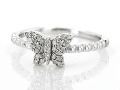 0.15ctw round white diamond, rhodium over sterling silver butterfly ring. Measures approximately 3/8"L x 1/4"W and is not sizeable. Fine Jewelry Butterfly Ring With Diamond Accents For Promise, Diamond Accents Butterfly Promise Ring, White Butterfly Ring With Diamond Accents For Promise, Silver Butterfly Ring With Diamond Accents For Promise, Butterfly Shaped Diamond Ring, White Gold Cubic Zirconia Butterfly Ring, Butterfly Shaped Diamond Ring In Fine Jewelry Style, Silver Diamond Butterfly Promise Ring, Anniversary White Gold Butterfly Ring With Diamond Accents