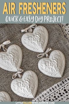 four white heart shaped cookies sitting on top of a doily covered table cloth with the words air fresheners quick and easy diy projects