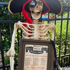 a skeleton dressed up as a pirate with a sign in front of it that says what's your pirate notes