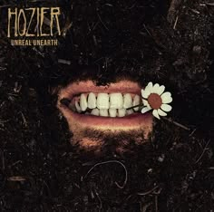 a man with a flower in his mouth and the words hozier on it's forehead